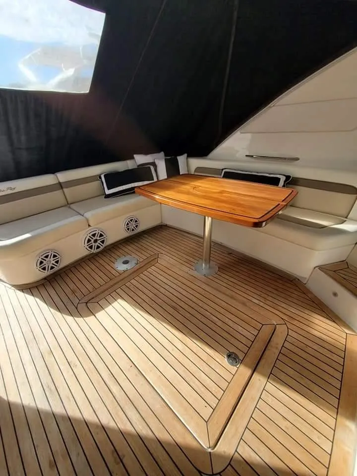 Slide: The Image of 2012 Sea Ray 540 Sundancer yacht interior with teak flooring and seating area. - 14