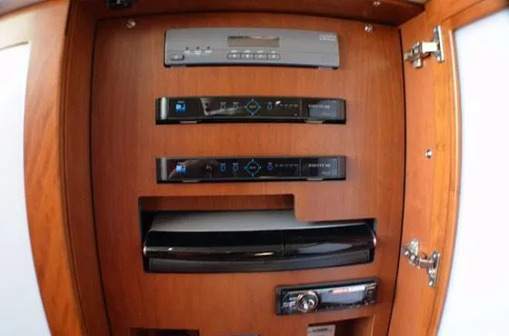 Slide: The Image of 2012 Sea Ray 540 Sundancer entertainment system with wooden cabinet and electronic components. - 25