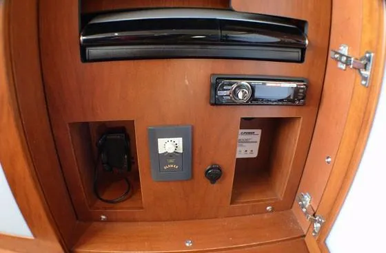 Slide: The Image of Control panel inside 2012 Sea Ray 540 Sundancer yacht with audio system and storage compartments. - 26