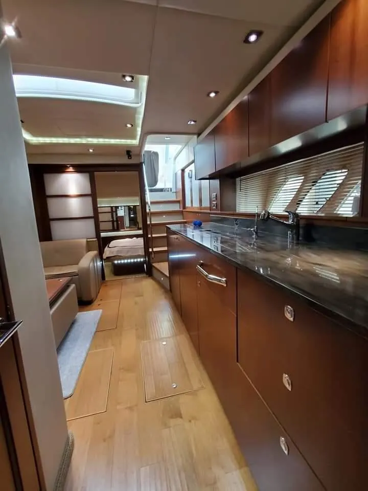 Slide: The Image of Luxurious interior of 2012 Sea Ray 540 Sundancer yacht with modern wood finishes. - 32