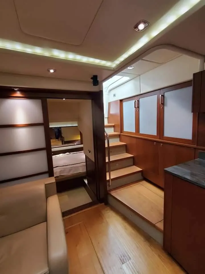 Slide: The Image of Luxurious interior of 2012 Sea Ray 540 Sundancer yacht with modern wood finishes. - 44
