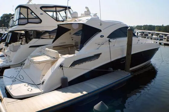 Slide: The Image of 2012 Sea Ray 540 Sundancer yacht docked at marina, sleek design, luxury vessel. - 46