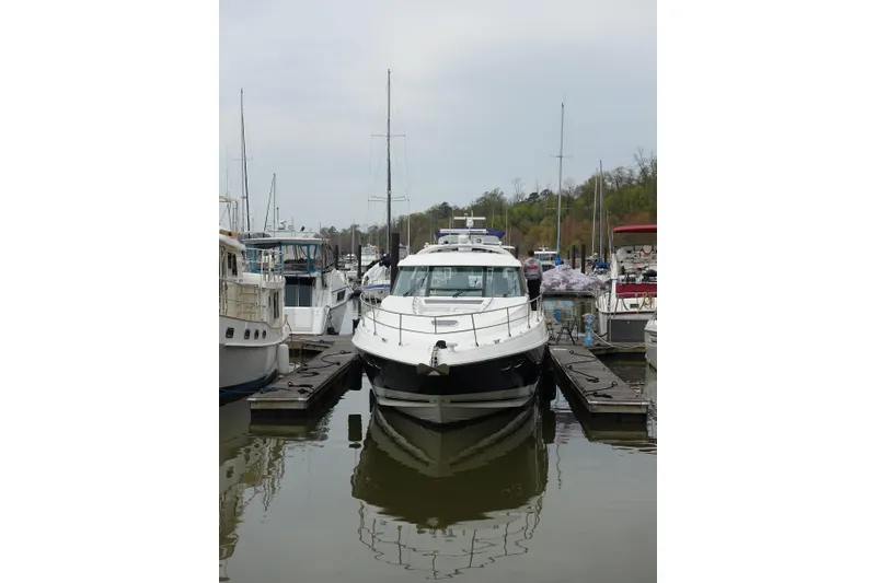 Slide: The Image of 2012 Sea Ray Sundancer 540 yacht docked at marina, surrounded by other boats. - 49