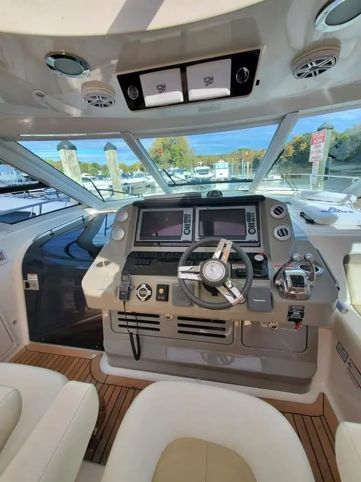 Slide: The Image of 2012 Sea Ray 540 Sundancer helm with modern navigation controls and panoramic view. - 5