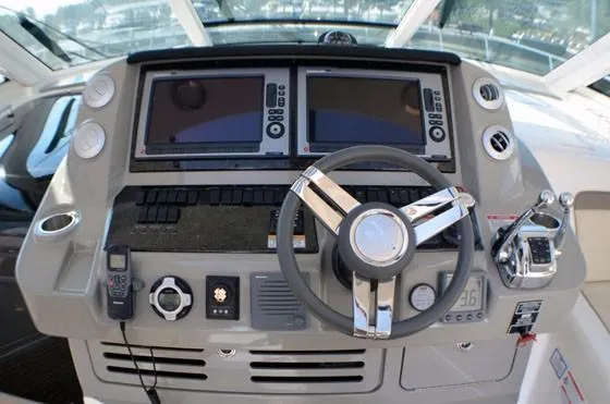 Slide: The Image of 2012 Sea Ray 540 Sundancer helm with dual displays and modern controls. - 6
