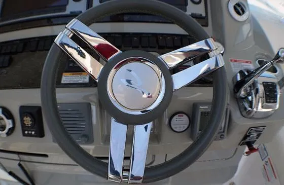 Slide: The Image of Steering wheel of 2012 Sea Ray 540 Sundancer yacht, featuring chrome accents and control panel. - 8