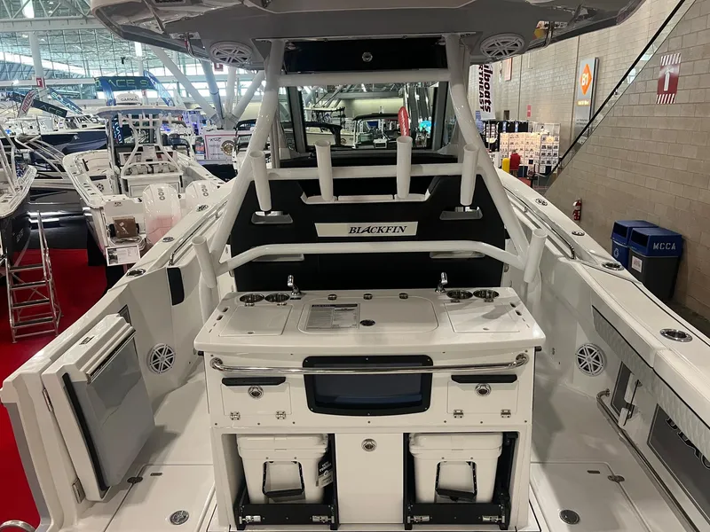 Slide: The Image of 2023 Blackfin 332 CC boat interior at a showroom, showcasing fishing and navigation features. - 10
