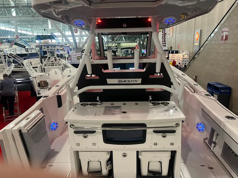 Slide: The Image of 2023 Blackfin 332 CC boat interior at a boat show, featuring modern design and equipment. - 11