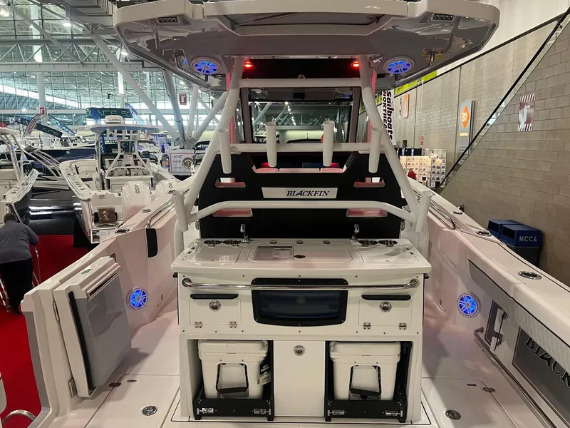 Slide: The Image of 2023 Blackfin 332 CC boat interior at a boat show, featuring modern amenities. - 12