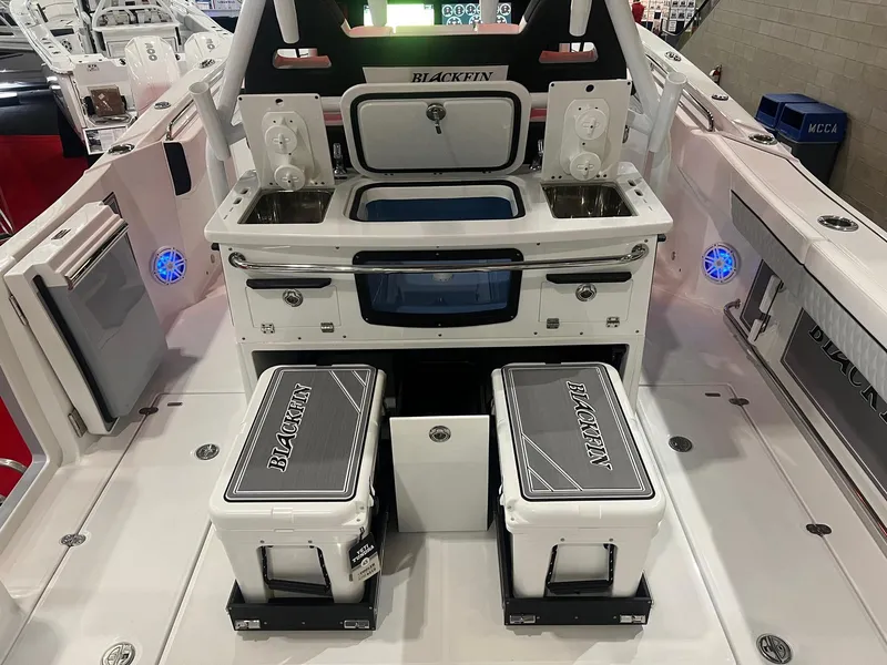Slide: The Image of 2023 Blackfin 332 CC boat interior with dual coolers and storage compartments. - 13