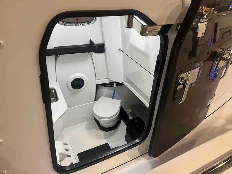 Slide: The Image of 2023 Blackfin 332 CC boat interior with compact marine toilet and sleek design. - 19