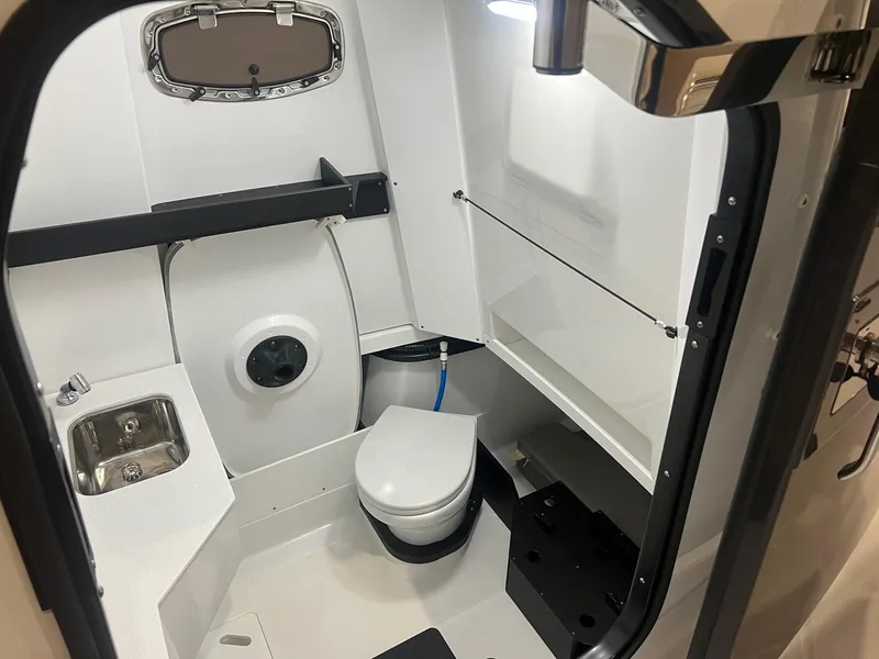 Slide: The Image of Interior of 2023 Blackfin 332 CC boat bathroom with sink and toilet. - 21