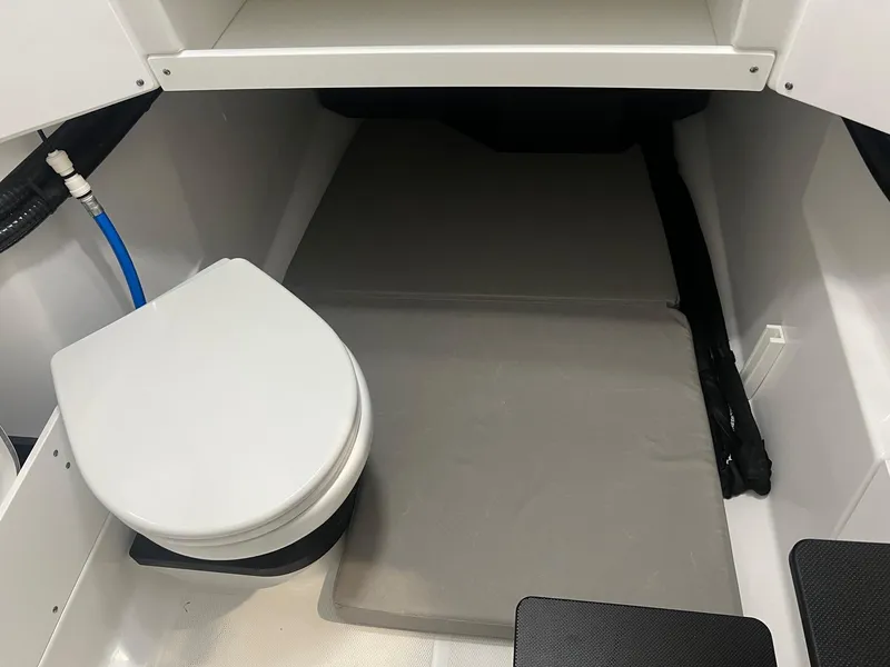 Slide: The Image of 2023 Blackfin 332 CC boat interior with toilet and sleeping area. - 22