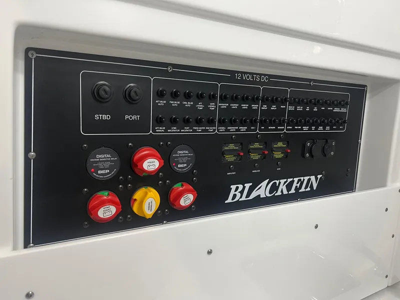 Slide: The Image of Blackfin 332 CC 2023 control panel with switches and dials for boat operations. - 23