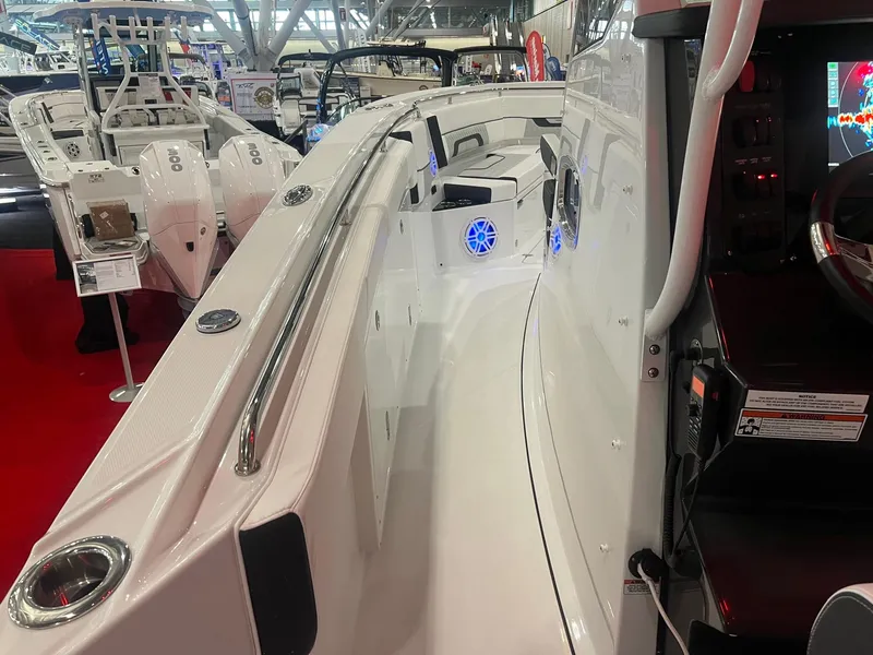 Slide: The Image of 2023 Blackfin 332 CC boat interior at a boat show, featuring sleek design and modern controls. - 24