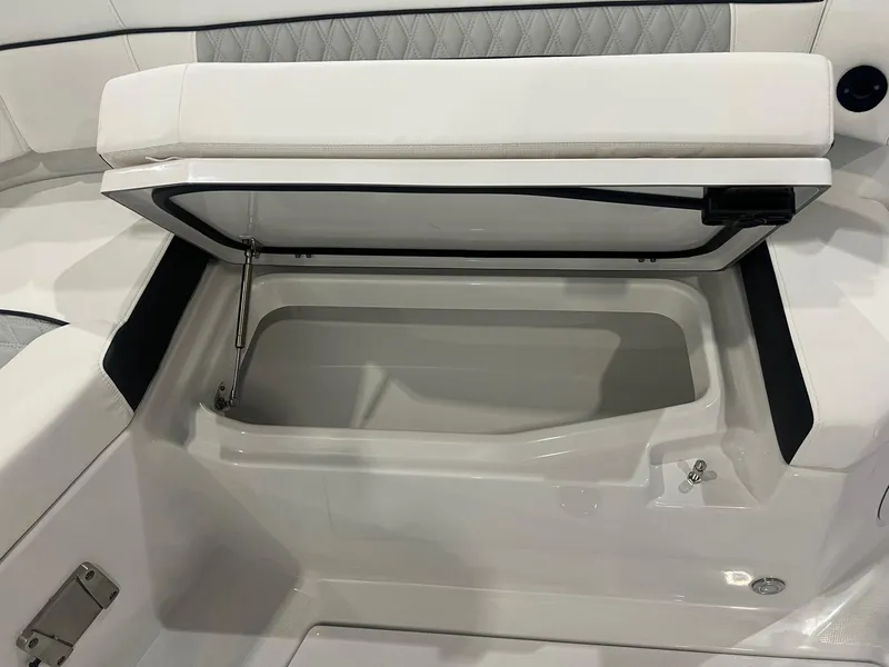 Slide: The Image of 2023 Blackfin 332 CC boat storage compartment with open lid, showcasing sleek interior design. - 31