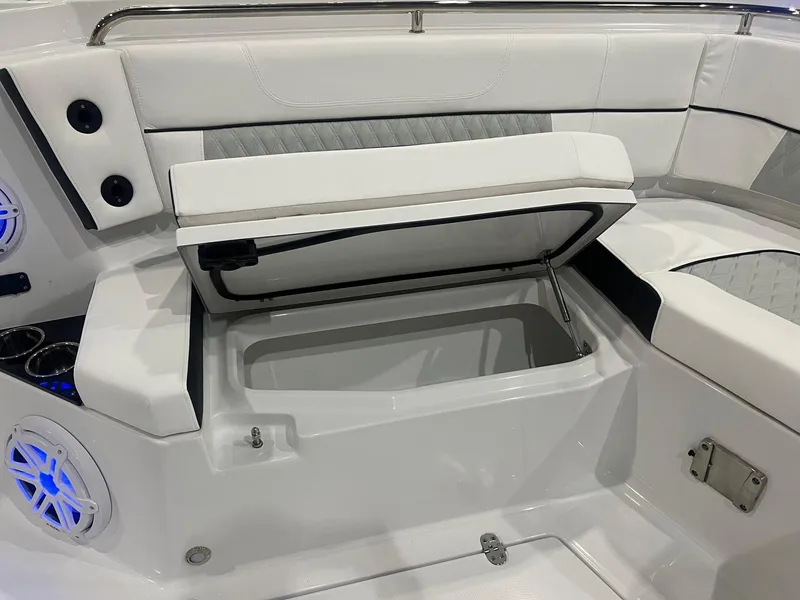 Slide: The Image of 2023 Blackfin 332 CC boat interior with open storage compartment and speakers. - 32