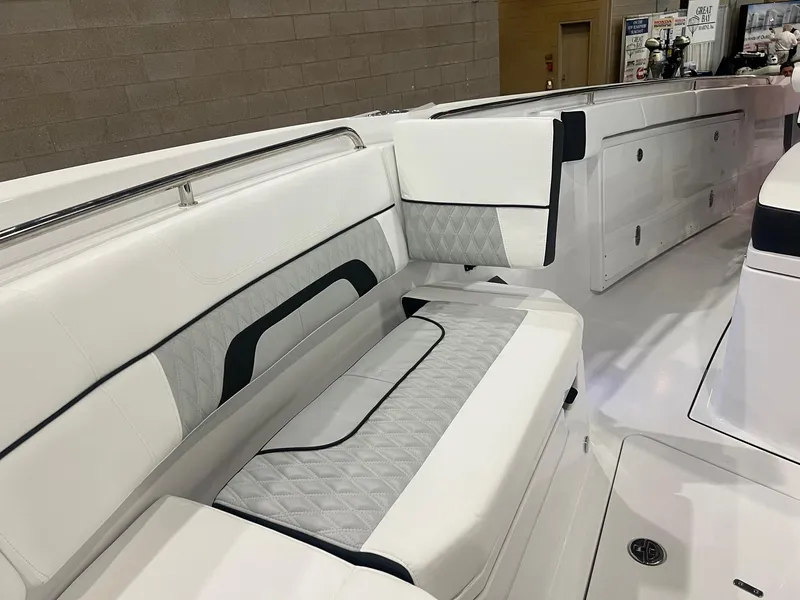 Slide: The Image of 2023 Blackfin 332 CC boat interior with white cushioned seating and sleek design. - 33