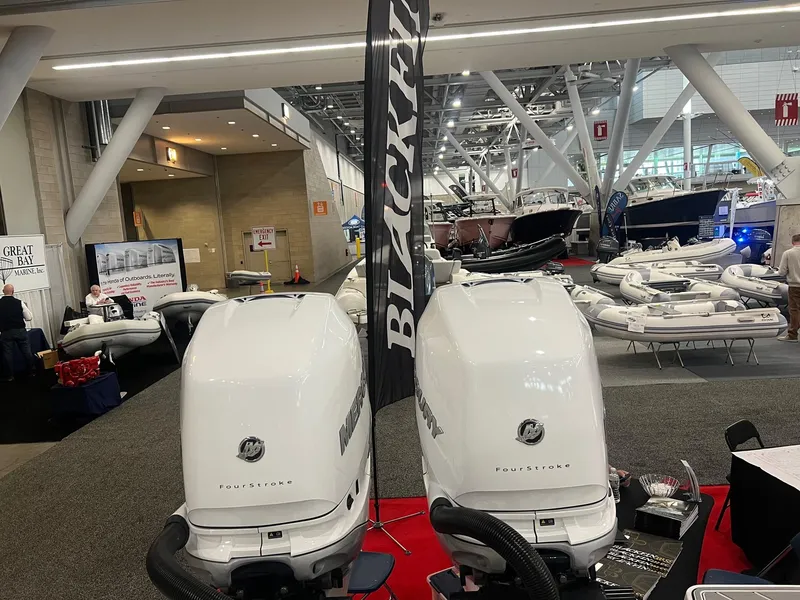 Slide: The Image of 2023 Blackfin 332 CC boat engines displayed at a boat show. - 4