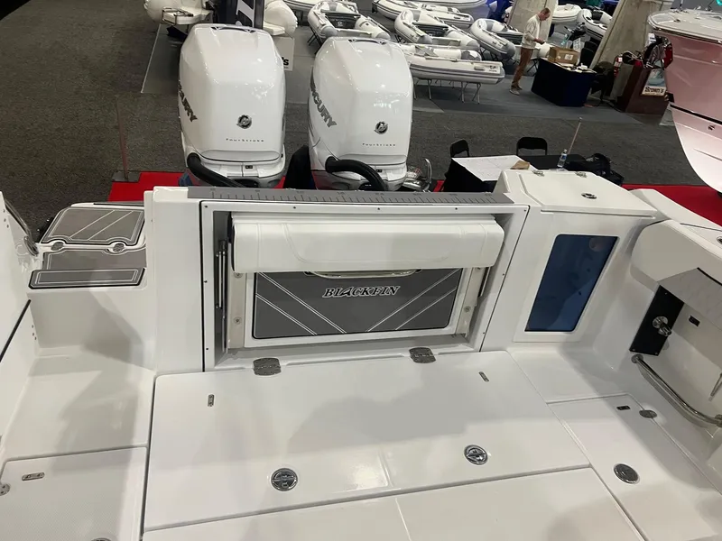 Slide: The Image of 2023 Blackfin 332 CC boat deck with dual outboard engines. - 6