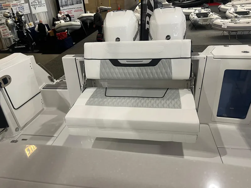 Slide: The Image of 2023 Blackfin 332 CC boat with white cushioned seating and dual engines. - 8