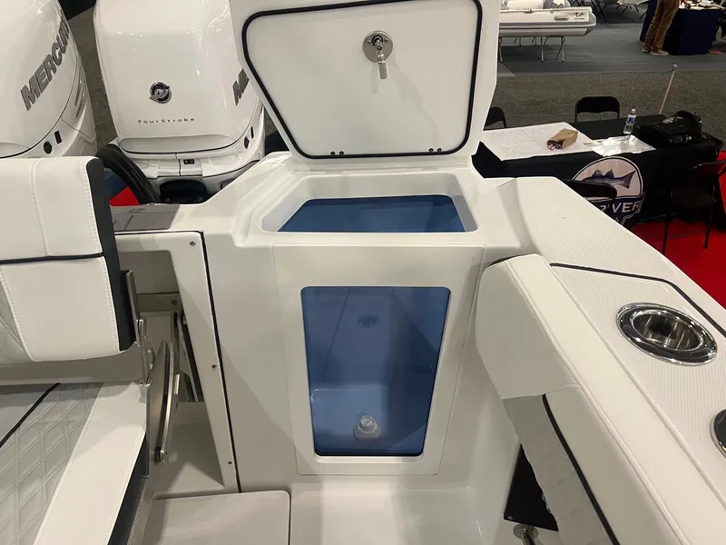 Slide: The Image of 2023 Blackfin 332 CC boat interior with open storage compartment and seating. - 9