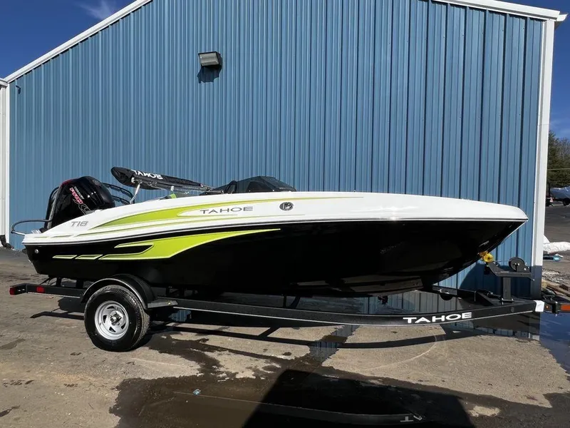 The Image of 2023 Tahoe T18 boat on trailer, parked by blue building. - 1