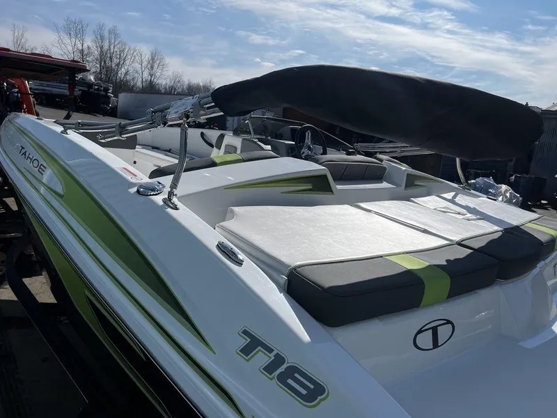 Slide: The Image of 2023 Tahoe T18 boat with green accents and sleek design under a clear sky. - 11
