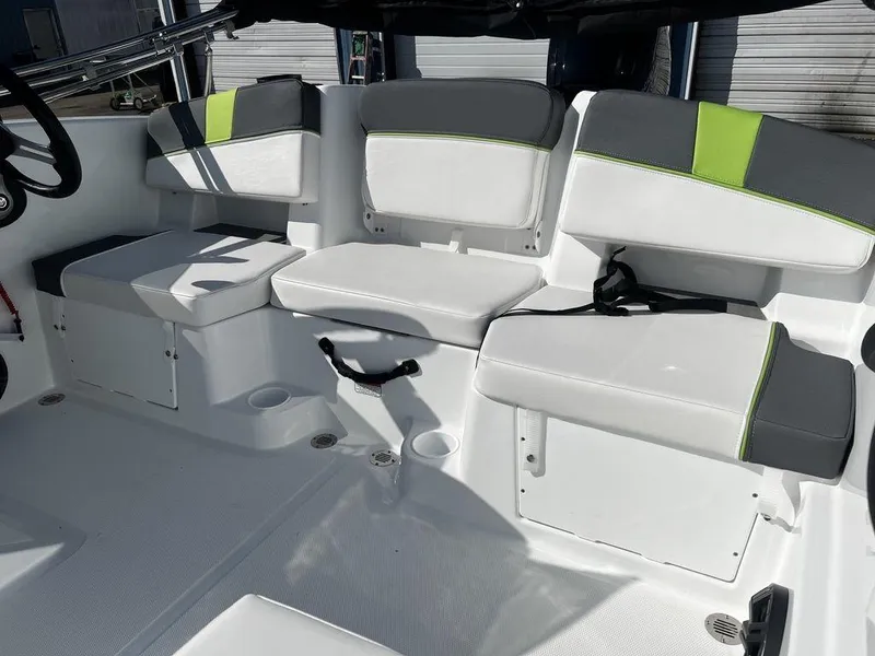 Slide: The Image of 2023 Tahoe T18 boat interior with white and gray seating, lime green accents. - 12