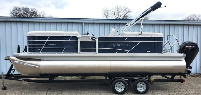 Slide: The Image of 2023 Sweetwater 2286 Xperience Split Bench OB pontoon boat on trailer. - 11