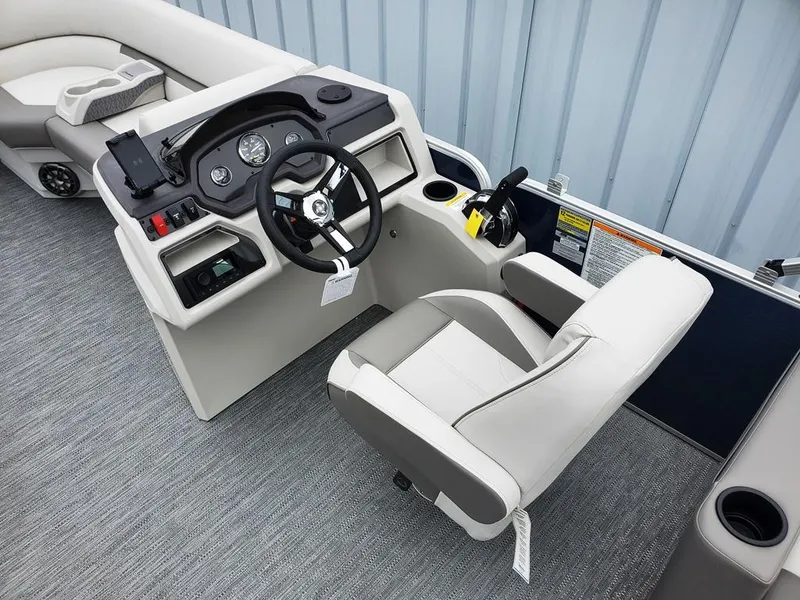 Slide: The Image of 2023 Sweetwater 2286 Xperience boat interior with steering console and seating. - 2