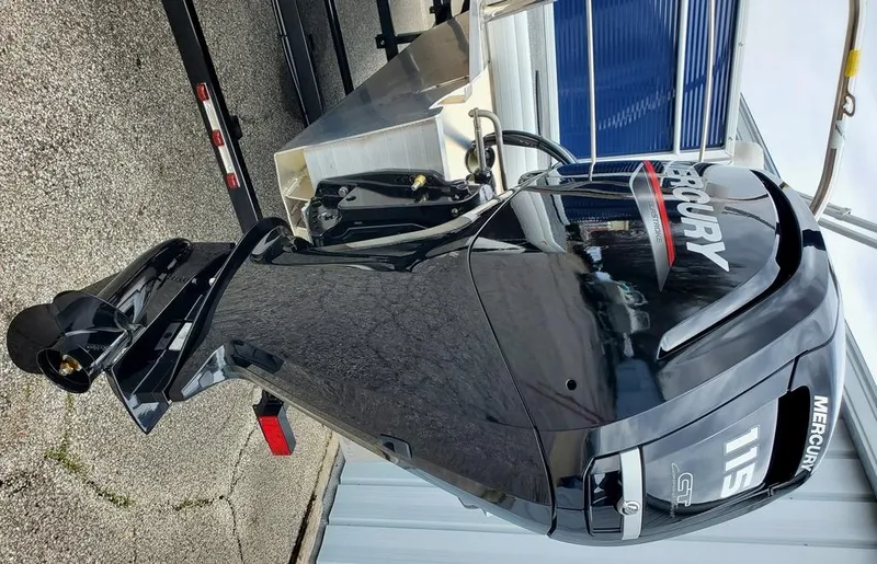 Slide: The Image of 2023 Sweetwater 2286 Xperience boat with Mercury outboard motor, parked on a trailer. - 7
