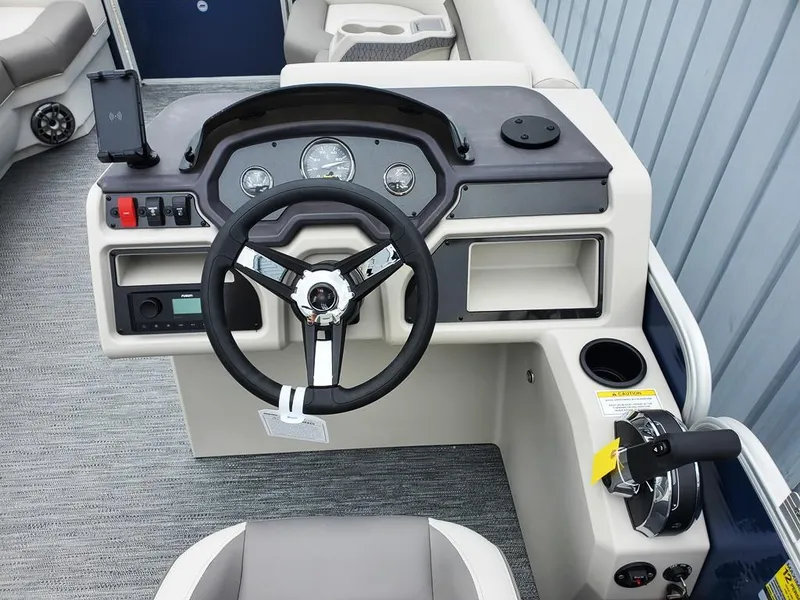 Slide: The Image of 2023 Sweetwater 2286 Xperience Split Bench OB boat dashboard with steering wheel and controls. - 8