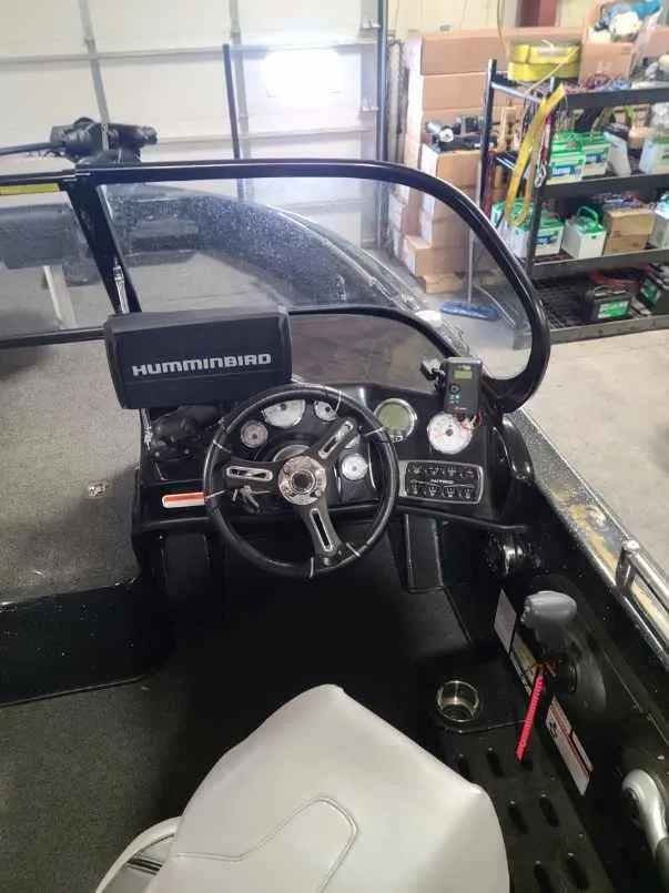 Slide: The Image of 2020 Nitro ZV19 Sport boat dashboard with Humminbird electronics in a garage. - 11