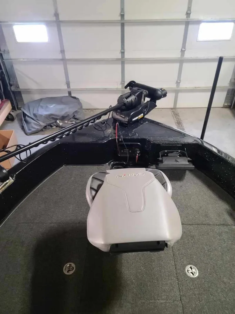 Slide: The Image of 2020 Nitro ZV19 Sport boat interior with trolling motor in garage. - 13