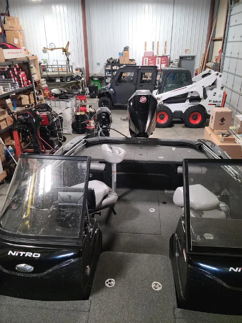 Slide: The Image of 2020 Nitro ZV19 Sport boat in a garage with various equipment. - 15