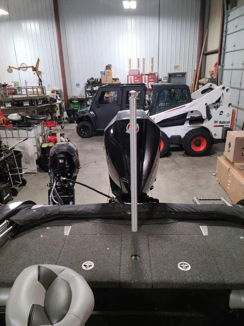 Slide: The Image of 2020 Nitro ZV19 Sport boat in a garage with various equipment. - 16