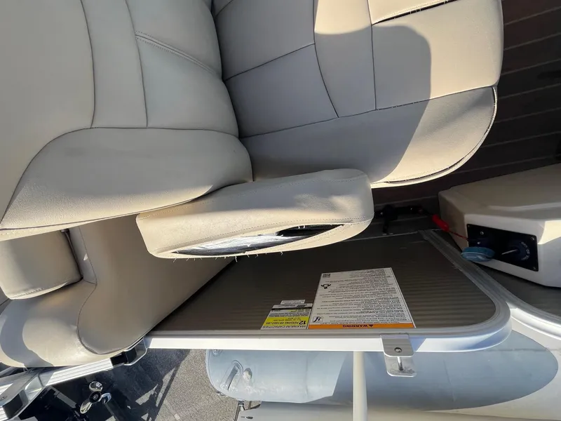 Slide: The Image of 2020 Sweetwater 2286 SB boat seat with armrest and safety instructions. - 12