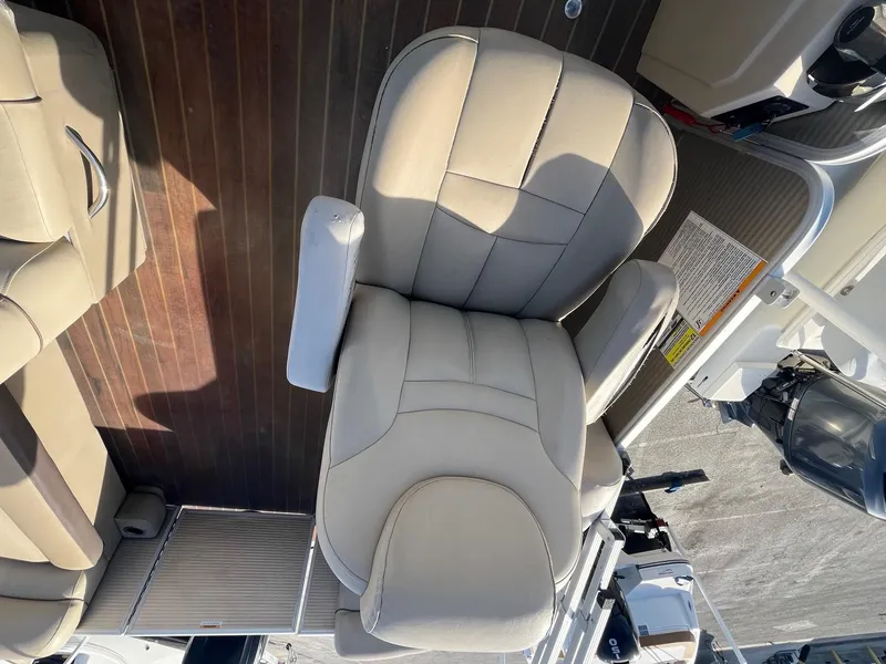 Slide: The Image of 2020 Sweetwater 2286 SB boat seat on wooden deck. - 13