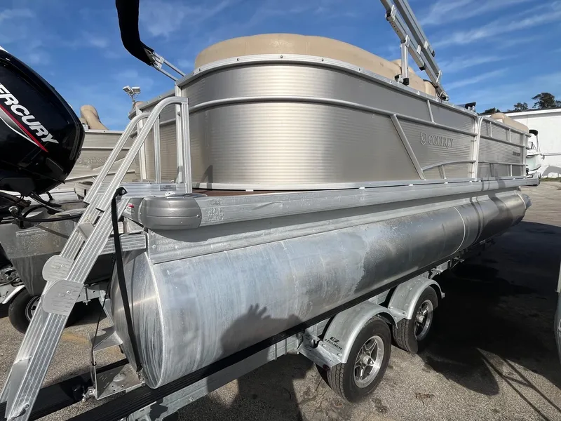 Slide: The Image of 2020 Sweetwater 2286 SB pontoon boat on trailer, side view under clear sky. - 3