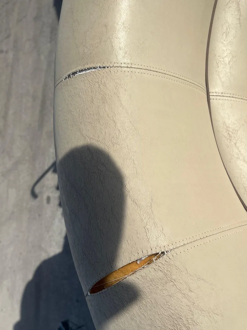 Slide: The Image of Torn upholstery on 2020 Sweetwater 2286 SB boat seat. - 5