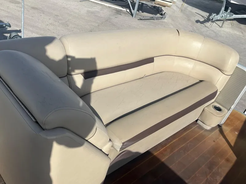 Slide: The Image of Beige seating on 2020 Sweetwater 2286 SB boat, wooden deck, outdoor setting. - 6