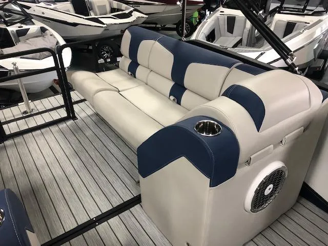 Slide: The Image of 2020 Montara 25' Surf Boss boat interior with blue and beige seating and cup holder. - 18