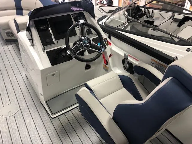 Slide: The Image of 2020 Montara 25' Surf Boss boat interior with steering wheel and seating. - 20