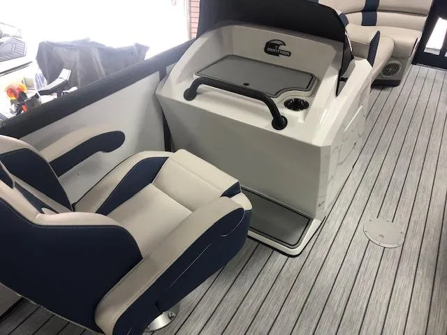 Slide: The Image of 2020 Montara 25' Surf Boss boat interior with blue and white seating and control console. - 21