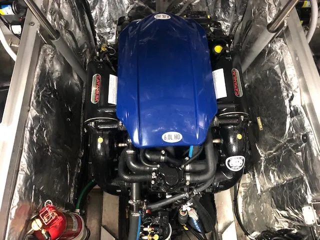 Slide: The Image of 2020 Montara 25' Surf Boss engine compartment with blue 6.0L HO engine. - 22