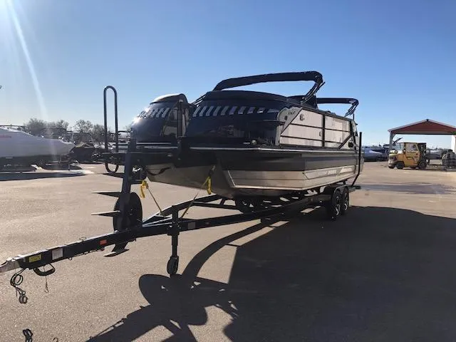 Slide: The Image of 2020 Montara 25' Surf Boss boat on trailer in sunny outdoor setting. - 6