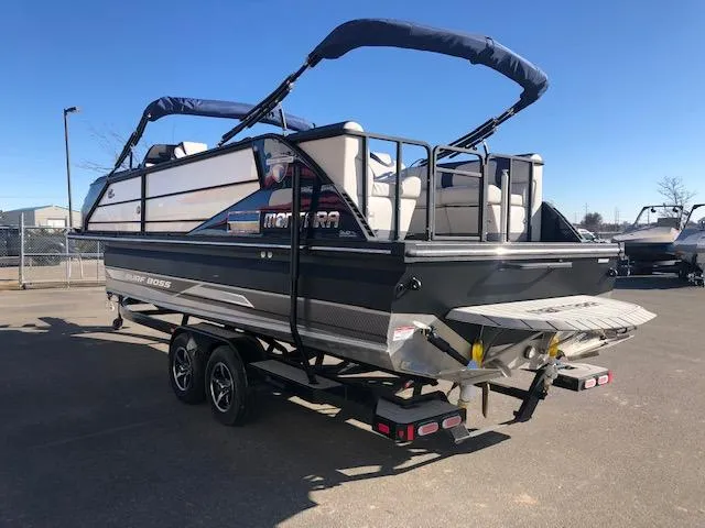Slide: The Image of 2020 Montara 25' Surf Boss boat on trailer, parked outdoors under clear blue sky. - 8