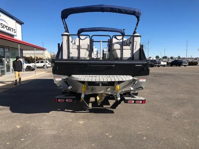 Slide: The Image of 2020 Montara 25' Surf Boss boat on trailer, rear view, parked outdoors. - 9