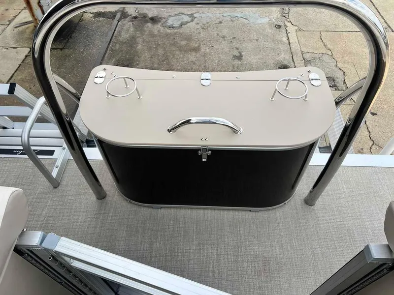 Slide: The Image of 2023 Avalon 2185 Venture CR2 boat interior with storage compartment and cup holders. - 16